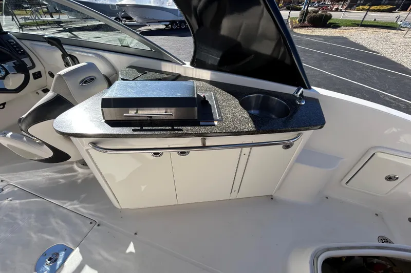 Slide: The Image of 2009 Chaparral Sunesta 264 boat interior with sink and grill on countertop. - 27