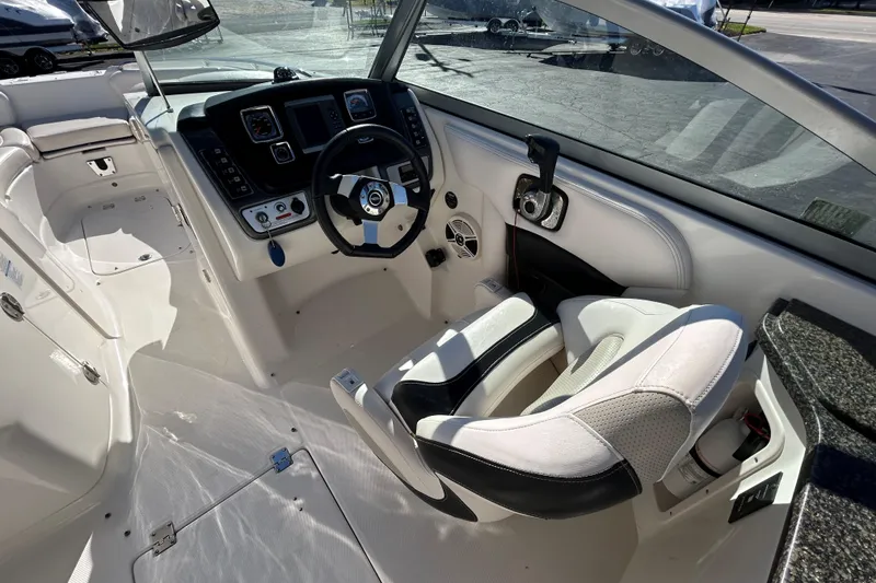 Slide: The Image of 2009 Chaparral Sunesta 264 boat interior with steering wheel and control panel. - 28