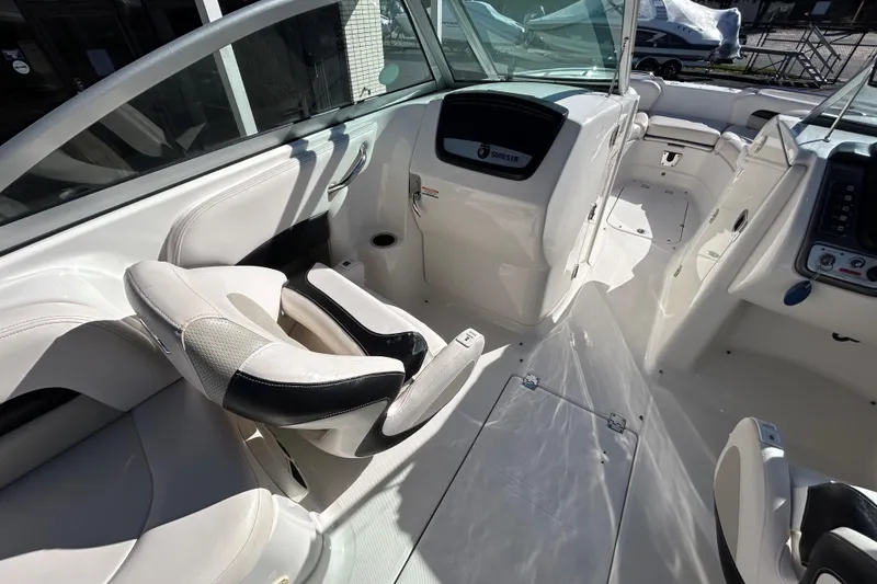 Slide: The Image of 2009 Chaparral Sunesta 264 boat interior with white seating and dashboard. - 29