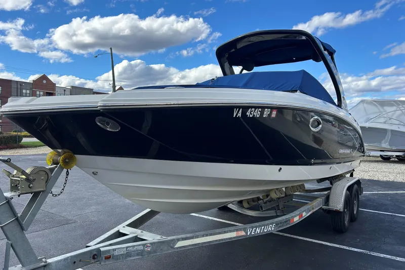 Slide: The Image of 2009 Chaparral Sunesta 264 boat on trailer under blue sky. - 3