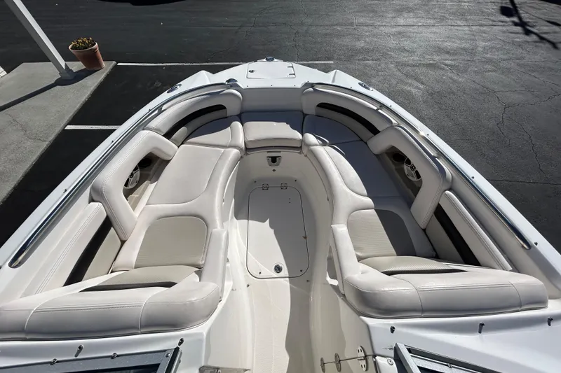 Slide: The Image of 2009 Chaparral Sunesta 264 boat interior with white cushioned seating. - 9