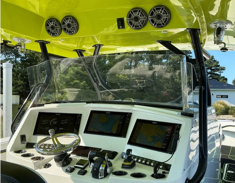 Slide: The Image of 2020 Prowler 42 boat dashboard with navigation screens and controls. - 12