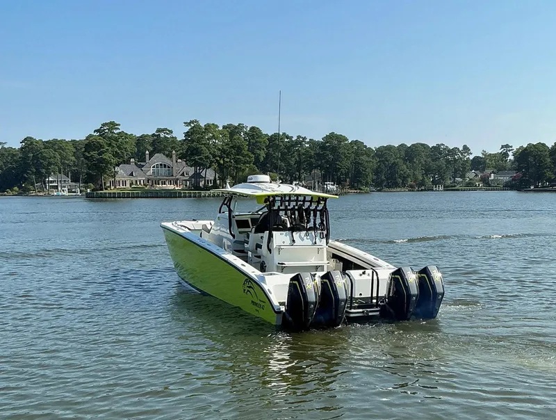 Slide: The Image of 2020 Prowler 42 boat with multiple engines on a serene lake. - 13