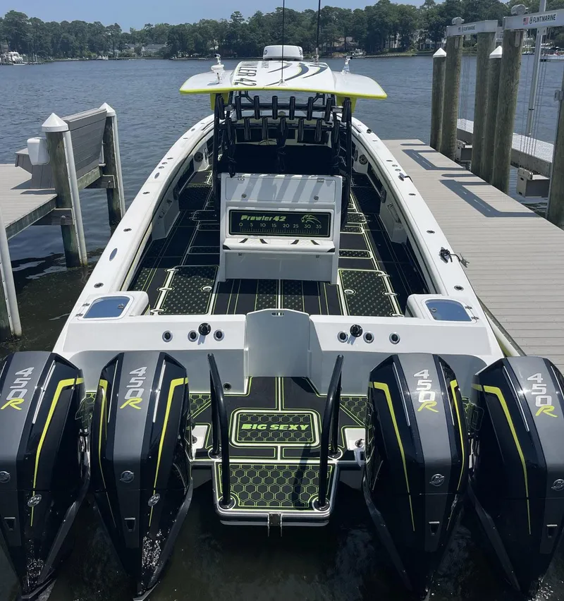 Slide: The Image of 2020 Prowler 42 boat with four powerful 450R engines docked by the water. - 14