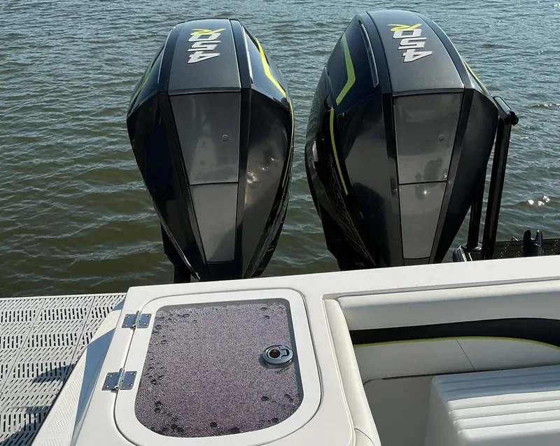 Slide: The Image of Twin outboard motors on a 2020 Prowler 42 boat, docked on calm water. - 21
