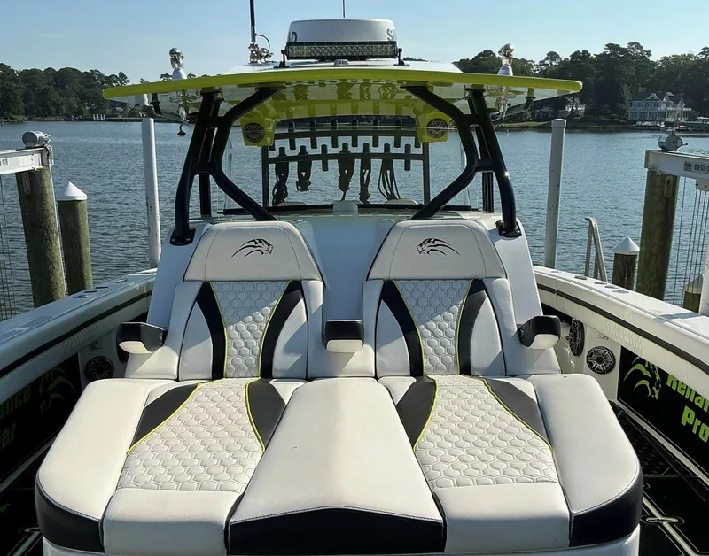 Slide: The Image of Luxury seating on a 2020 Prowler 42 boat, docked by a scenic waterfront. - 23