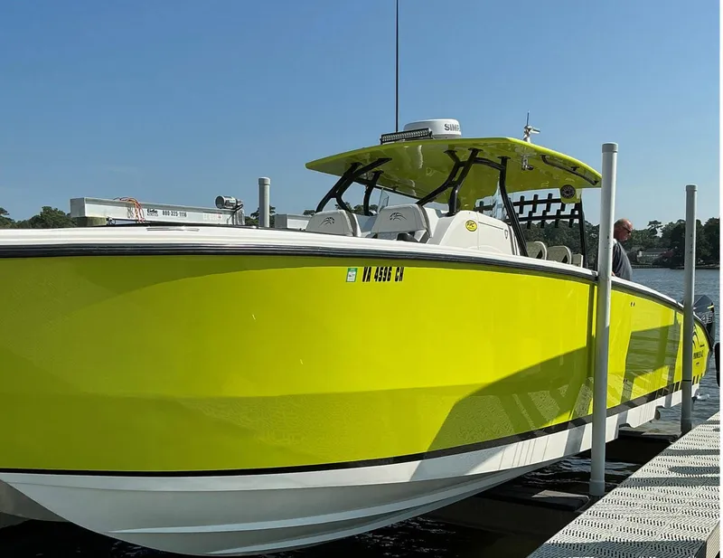 Slide: The Image of Bright yellow 2020 Prowler 42 boat docked on a sunny day. - 6