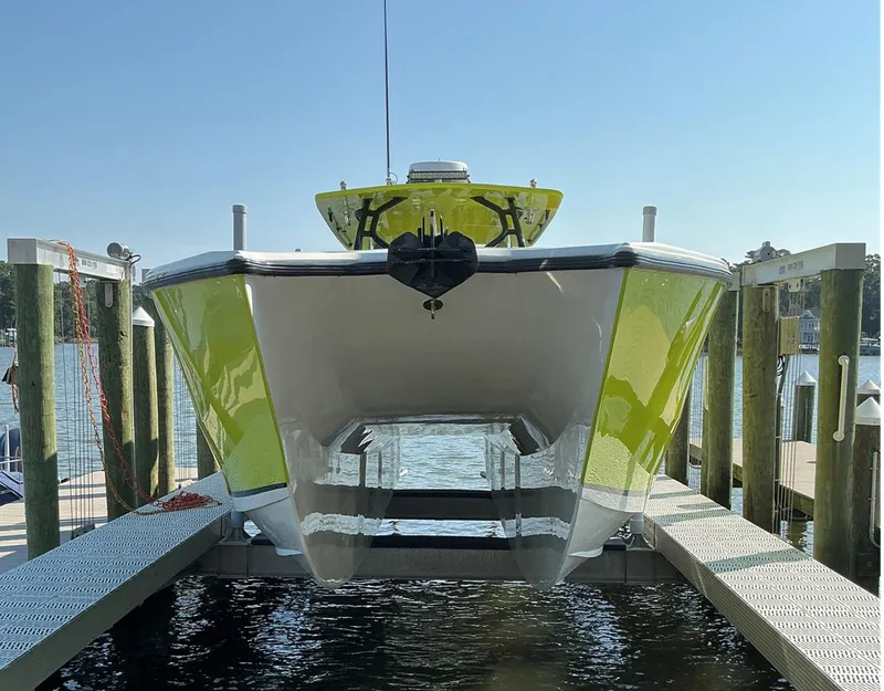 Slide: The Image of 2020 Prowler 42 catamaran in dock, featuring a sleek green and white design. - 8