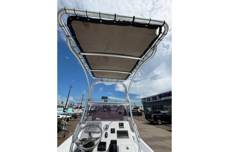 Slide: The Image of 2023 Shoalwater 23 Catamaran boat console with T-top under a clear sky. - 10