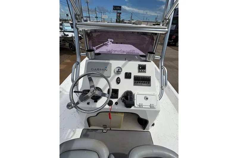 Slide: The Image of 2023 Shoalwater 23 Catamaran dashboard with Garmin navigation and steering wheel. - 16