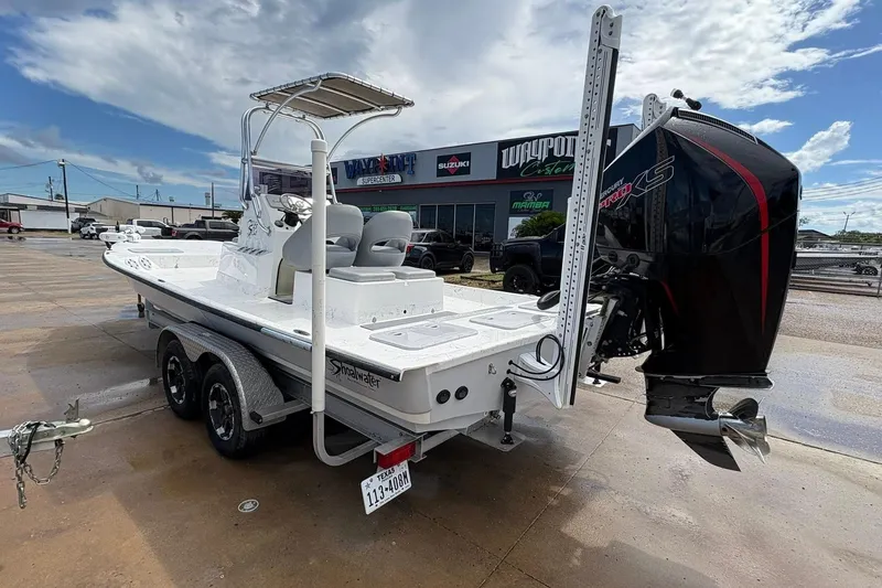 Slide: The Image of 2023 Shoalwater 23 Catamaran boat on trailer, parked outdoors near dealership. - 3