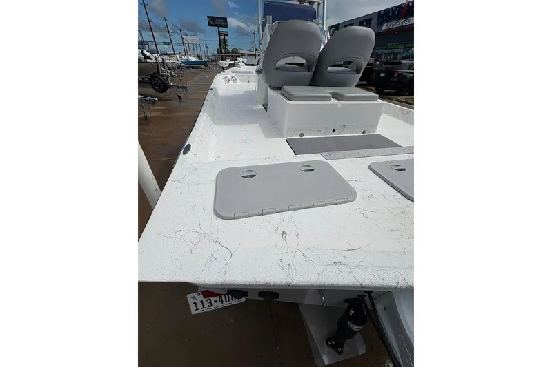 Slide: The Image of 2023 Shoalwater 23 Catamaran boat with dual seats and storage compartments, displayed outdoors. - 4