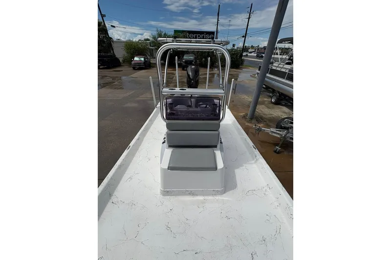 Slide: The Image of 2023 Shoalwater 23 Catamaran boat with center console and seating, parked outdoors. - 5
