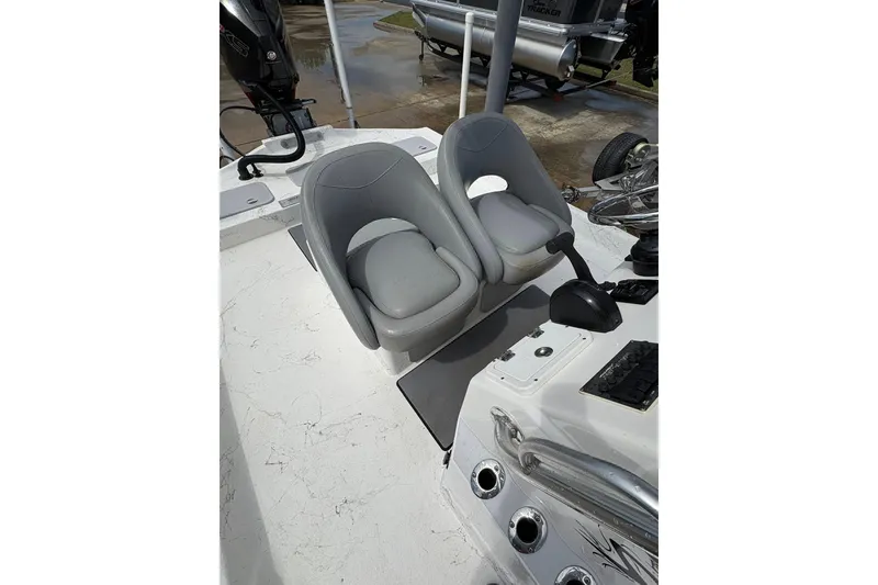 Slide: The Image of 2023 Shoalwater 23 Catamaran interior with dual gray seats and control panel. - 7