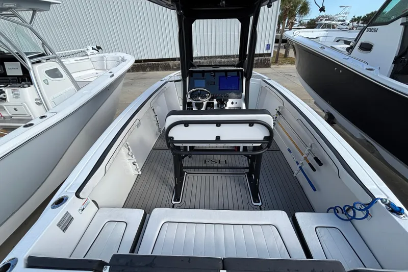 Slide: The Image of 2021 Yamaha Boats 255 FSH Sport E interior with modern helm and seating. - 10