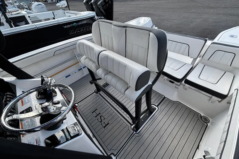 Slide: The Image of 2021 Yamaha Boats 255 FSH Sport E interior with helm and seating area. - 13