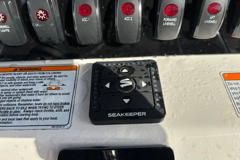 Slide: The Image of Control panel of 2021 Yamaha Boats 255 FSH Sport E with Seakeeper system and warning labels. - 19