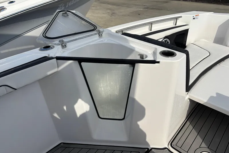 Slide: The Image of 2021 Yamaha Boats 255 FSH Sport E interior detail with seating and storage. - 23