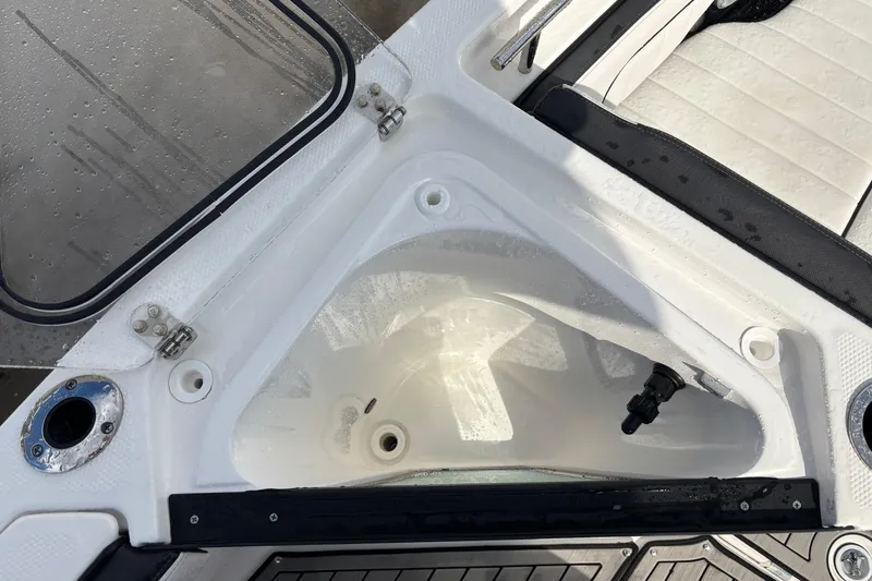 Slide: The Image of 2021 Yamaha Boats 255 FSH Sport E interior compartment with open hatch and seating. - 24
