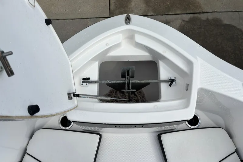 Slide: The Image of 2021 Yamaha Boats 255 FSH Sport E anchor storage compartment, open and empty. - 33