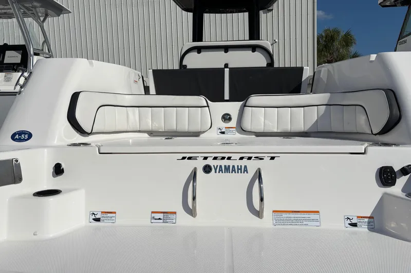 Slide: The Image of 2021 Yamaha Boats 255 FSH Sport E, rear seating and JetBlast logo, white exterior. - 38