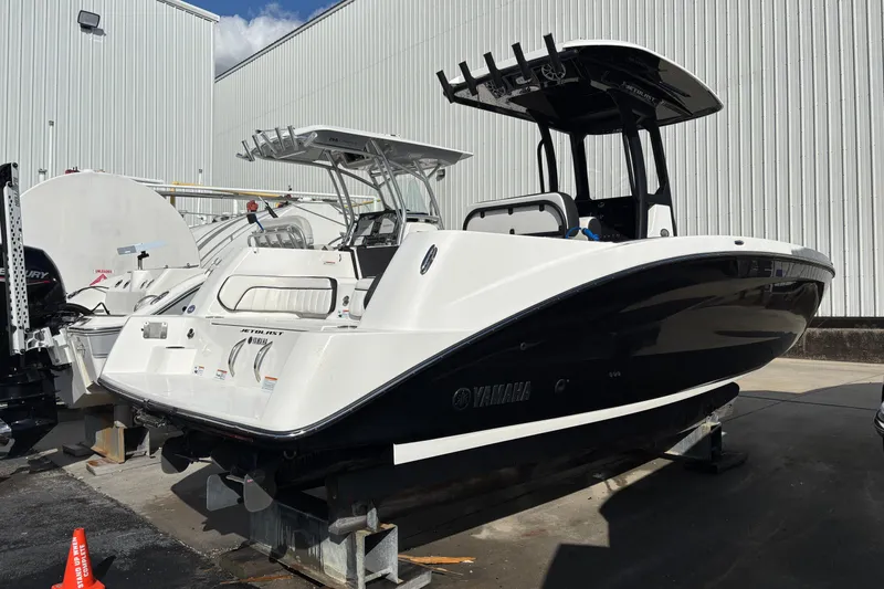 Slide: The Image of 2021 Yamaha Boats 255 FSH Sport E, sleek design, docked outdoors. - 5