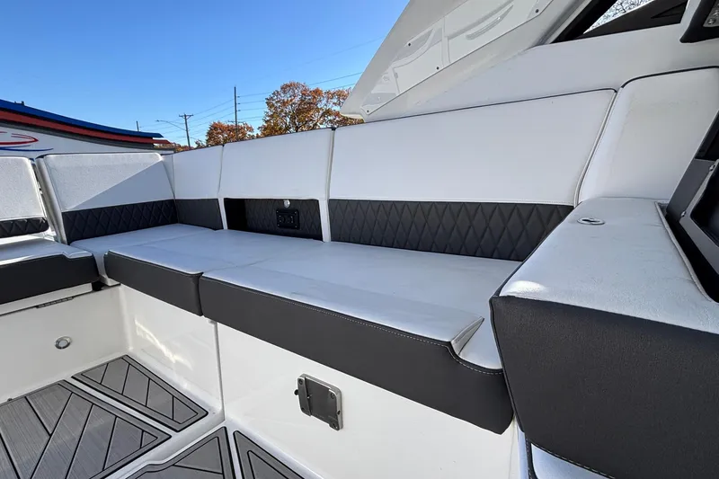 Slide: The Image of 2023 Monterey 385SS Super Sport boat interior with sleek white seating and modern design. - 12