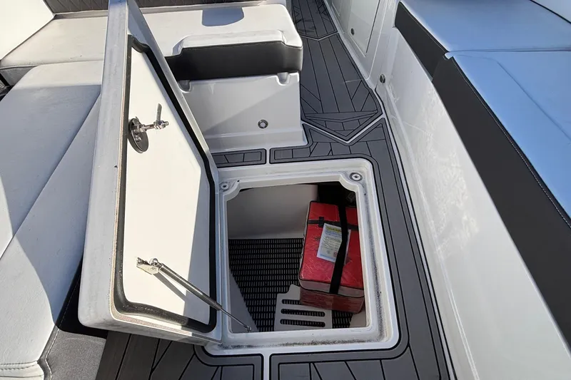 Slide: The Image of 2023 Monterey 385SS Super Sport boat storage compartment with red item inside. - 30