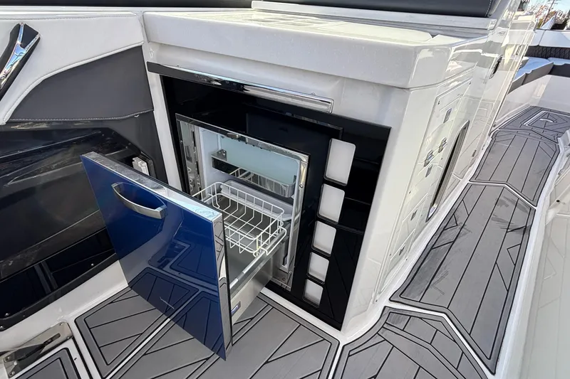 Slide: The Image of 2023 Monterey 385SS Super Sport boat with open onboard refrigerator. - 31
