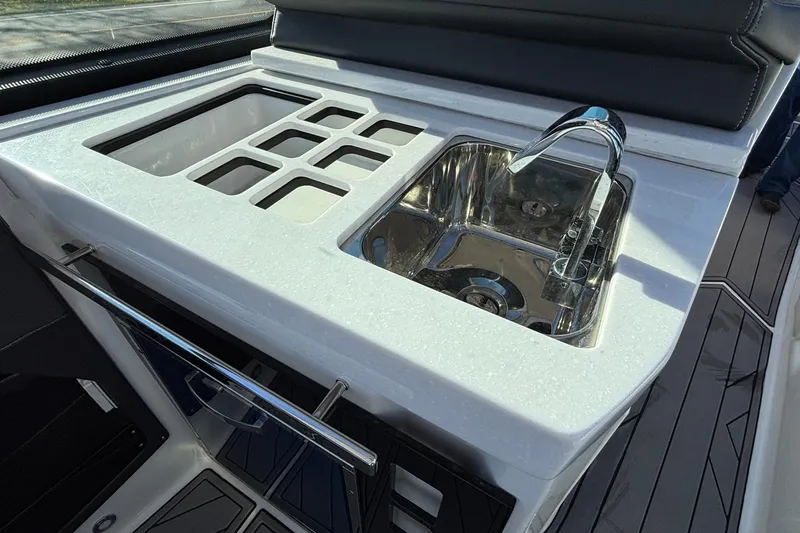 Slide: The Image of 2023 Monterey 385SS Super Sport boat kitchen with sink and storage compartments. - 33