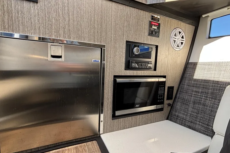 Slide: The Image of 2023 Monterey 385SS Super Sport interior with stainless appliances and modern audio system. - 35