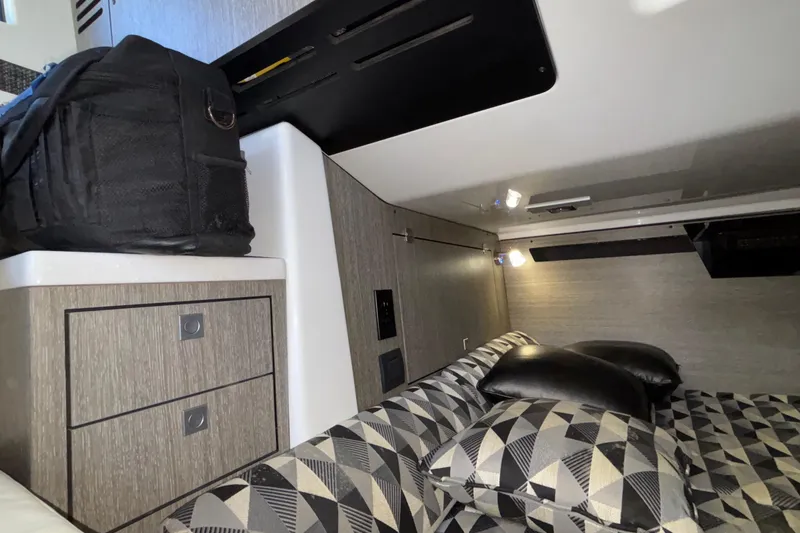 Slide: The Image of 2023 Monterey 385SS Super Sport cabin interior with geometric-patterned cushions and storage. - 37