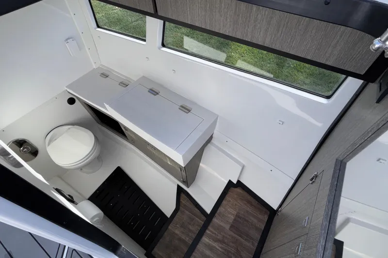 Slide: The Image of 2023 Monterey 385SS Super Sport boat interior bathroom with modern fixtures and wood accents. - 41