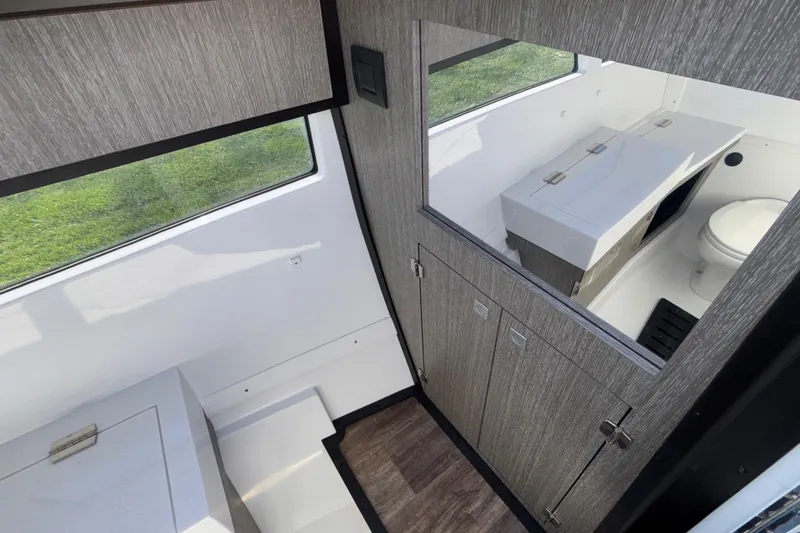 Slide: The Image of Interior of 2023 Monterey 385SS Super Sport boat, featuring modern bathroom design. - 43