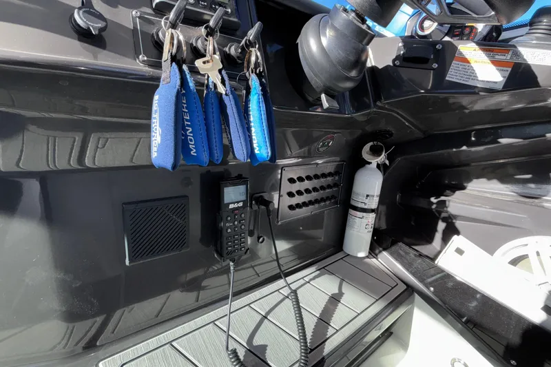 Slide: The Image of 2023 Monterey 385SS Super Sport dashboard with keys, radio, and fire extinguisher. - 48