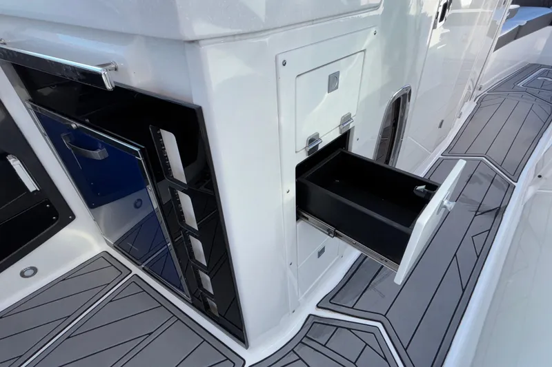 Slide: The Image of 2023 Monterey 385SS Super Sport boat interior with open storage compartments. - 50