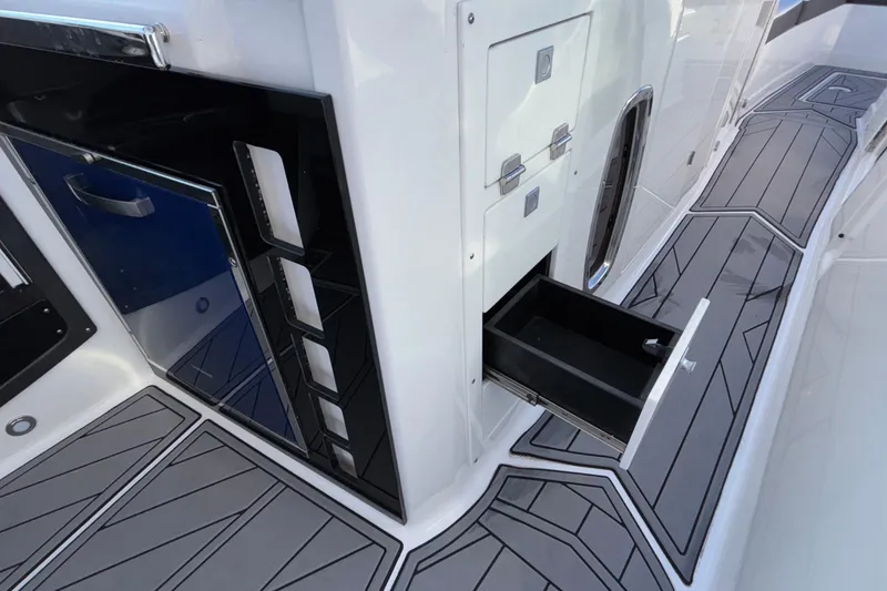 Slide: The Image of 2023 Monterey 385SS Super Sport boat interior with open storage drawer. - 51