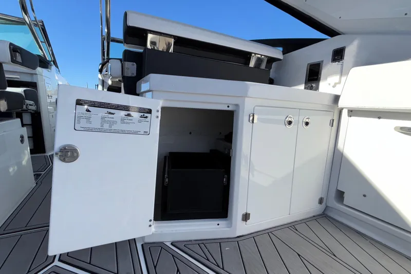 Slide: The Image of 2023 Monterey 385SS Super Sport boat interior with open storage compartment. - 55