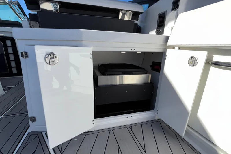Slide: The Image of 2023 Monterey 385SS Super Sport boat storage compartment with open doors. - 56