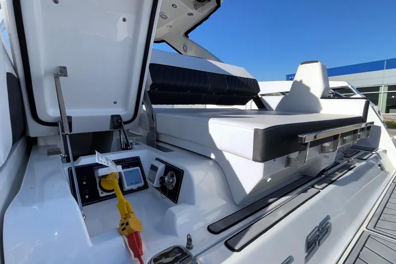 Slide: The Image of 2023 Monterey 385SS Super Sport boat interior with seating and control panel. - 61