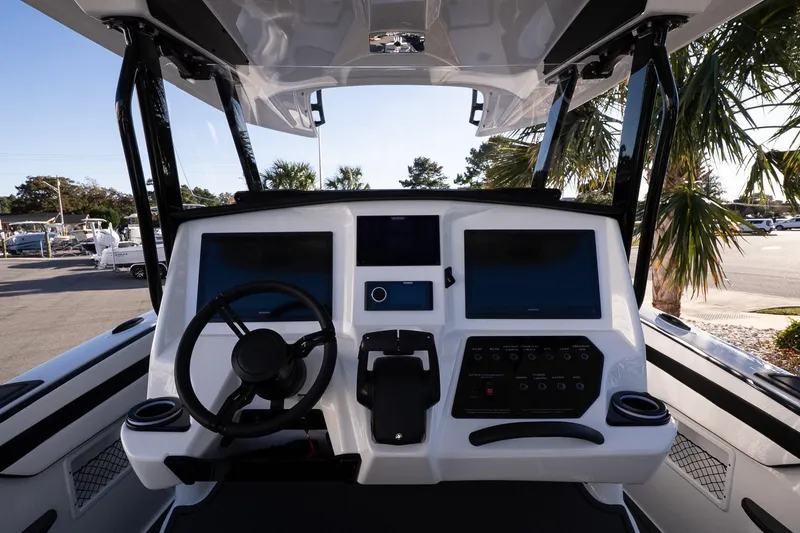 Slide: The Image of 2026 Sunsation 32 CCX boat dashboard with dual screens and steering wheel. - 11