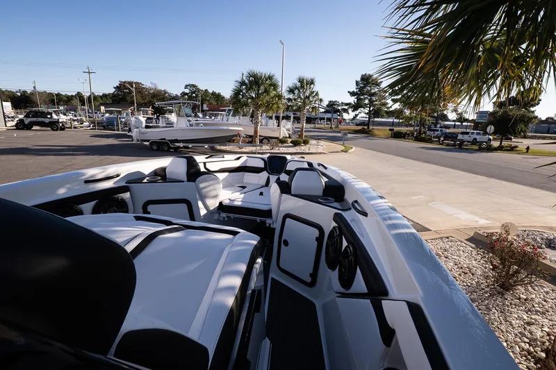 Slide: The Image of 2026 Sunsation 32 CCX boat interior with sleek seating and modern design in a sunny outdoor setting. - 18