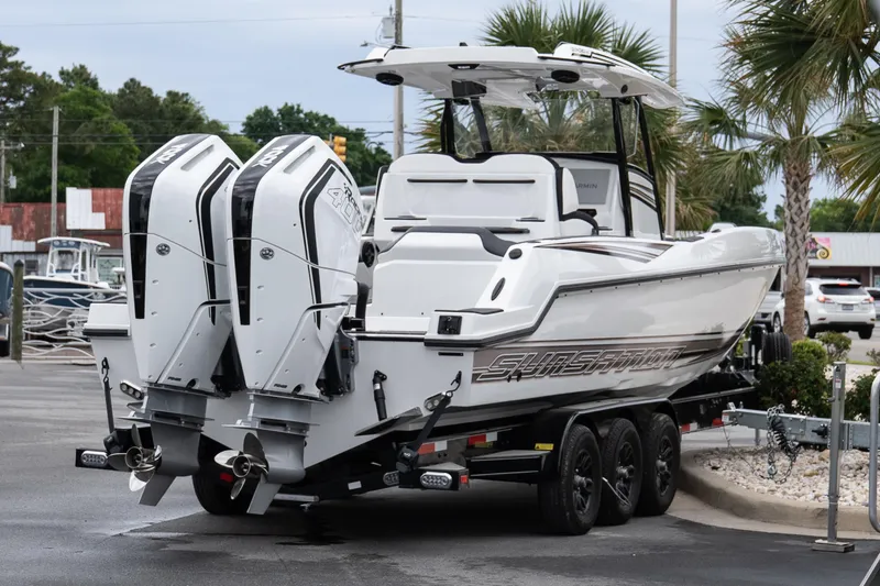 Slide: The Image of 2026 Sunsation 32 CCX boat with dual outboard engines on a trailer. - 30