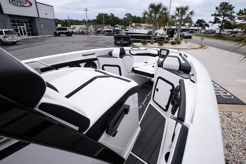 Slide: The Image of 2026 Sunsation 32 CCX boat interior with sleek seating and modern design at a dealership. - 34