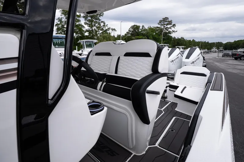 Slide: The Image of 2026 Sunsation 32 CCX boat interior with sleek white and black seating design. - 37