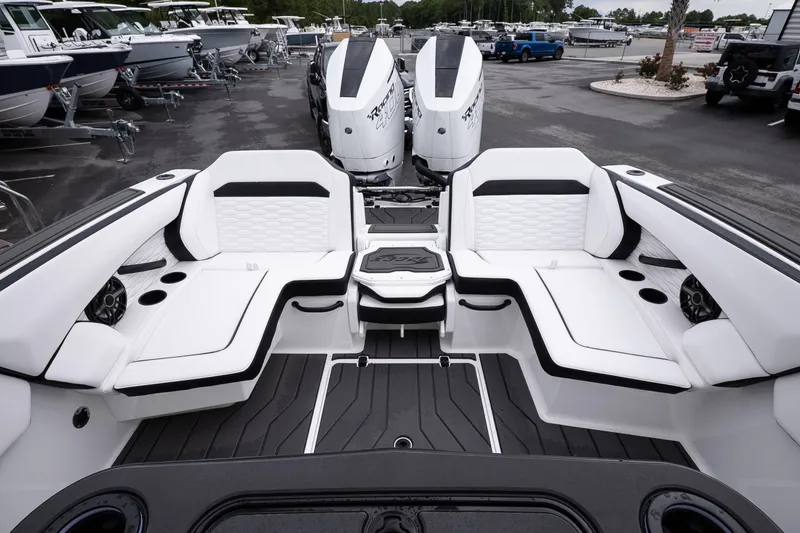 Slide: The Image of 2026 Sunsation 32 CCX boat interior with luxurious seating and twin engines in a marina setting. - 39