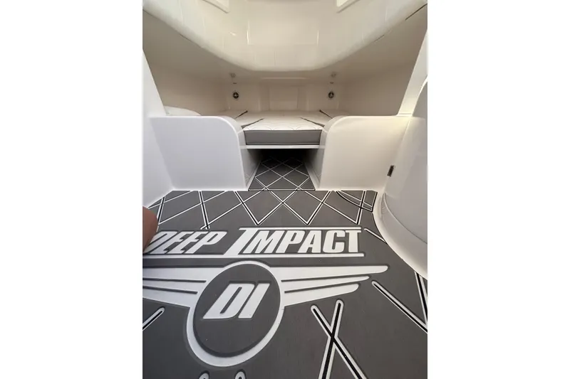 Slide: The Image of 2026 Deep Impact 399 Sport boat interior with luxurious seating and scenic waterfront view. - 13