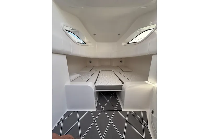 Slide: The Image of Luxury interior of 2026 Deep Impact 399 Sport boat with elegant seating and scenic waterfront view. - 14