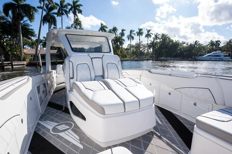 Slide: The Image of Luxury seating on 2026 Deep Impact 399 Sport boat, with waterfront view. - 19
