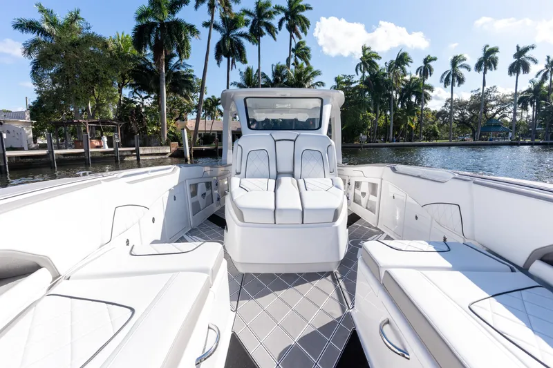 Slide: The Image of Luxury seating on 2026 Deep Impact 399 Sport boat, featuring elegant design and palm tree backdrop. - 20